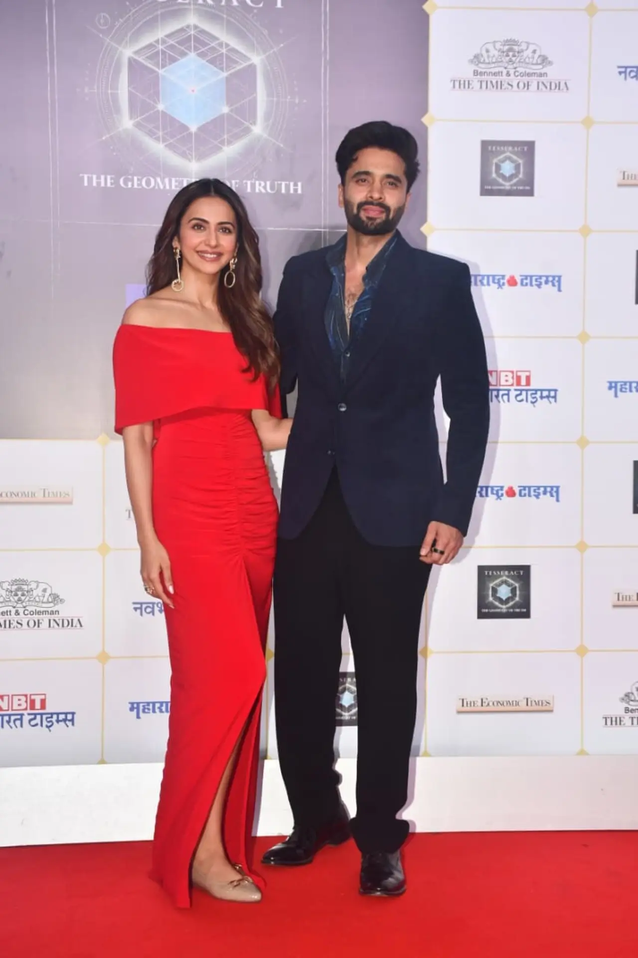 Rakul Preet Singh and Jackky Bhagnani made a stylish appearance together on the red carpet. Rakul turned heads in a striking off-shoulder red gown featuring ruched detailing and a thigh-high slit. Jackky complemented her look in a sharp navy blazer.